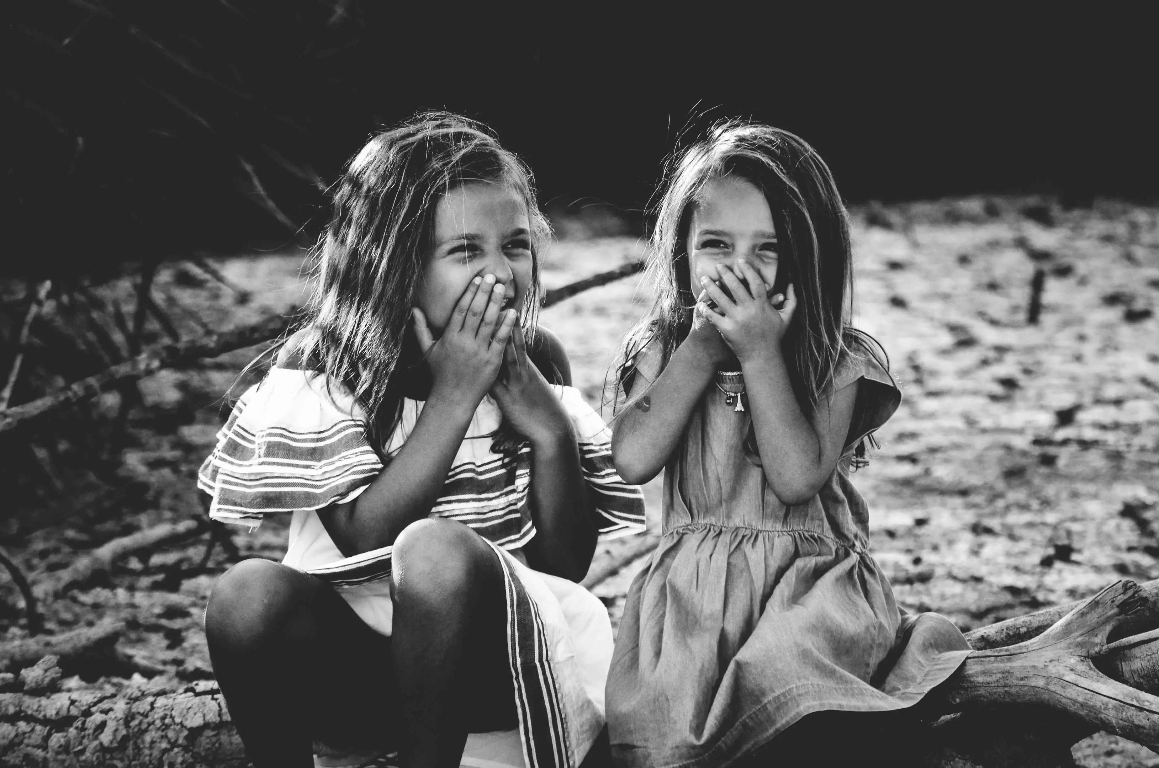 Two giggling kids as good friends